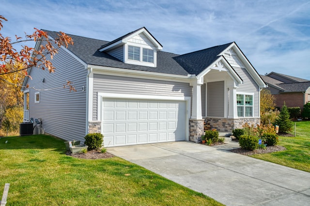 craftsman-style home featuring a garage, central air condition unit, and a front lawn