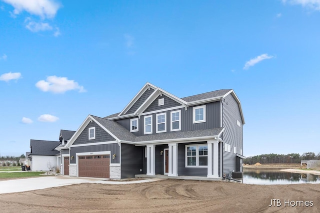 view of front facade featuring a water view and a garage