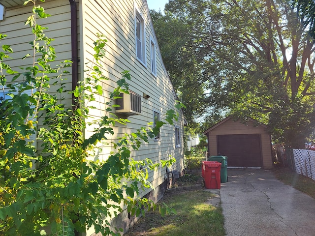 view of home's exterior with a garage and an outbuilding