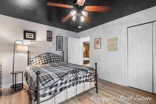 bedroom featuring a closet, hardwood / wood-style floors, and ceiling fan