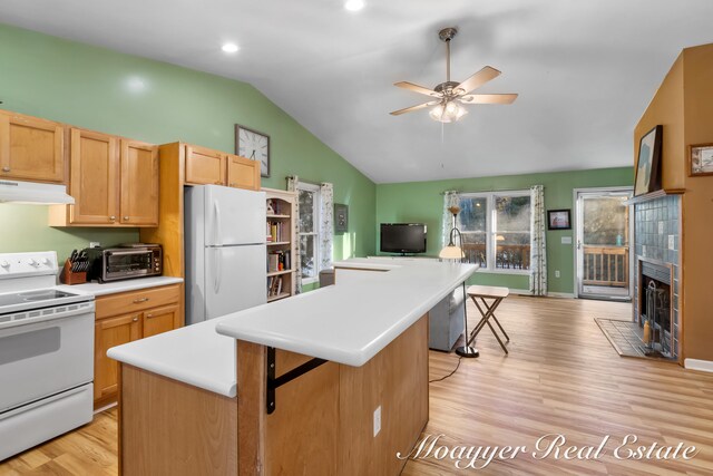 kitchen featuring a center island, plenty of natural light, and white appliances