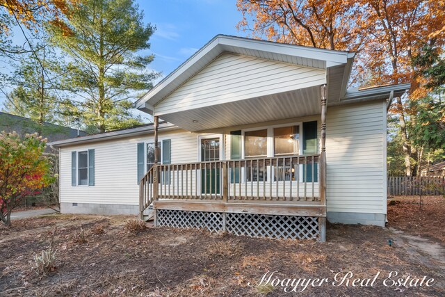 back of property with a wooden deck