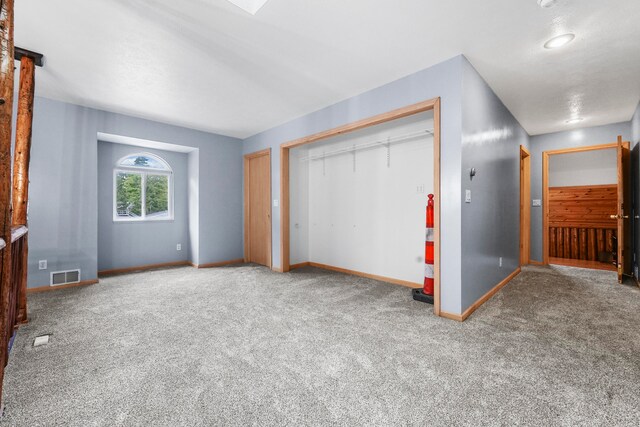 unfurnished bedroom with a closet and carpet flooring