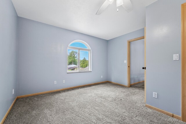 spare room with ceiling fan and carpet floors