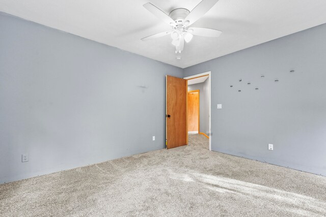 spare room with light carpet and ceiling fan