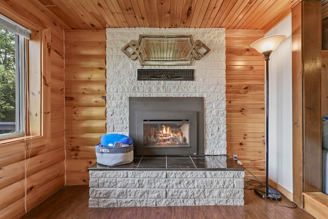 interior details featuring wooden ceiling, wood-type flooring, and rustic walls