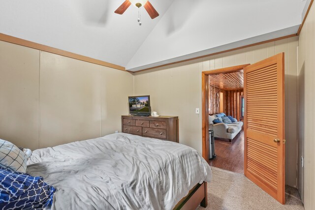 bedroom with ceiling fan, high vaulted ceiling, and carpet