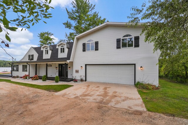 view of front of property featuring covered porch and a garage