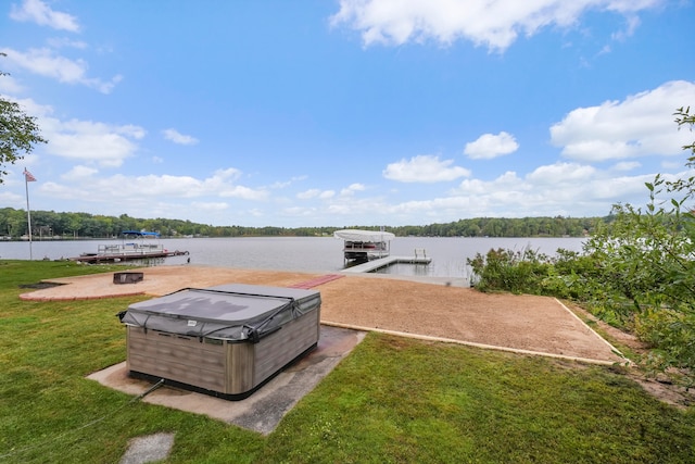 view of dock with a water view and a lawn