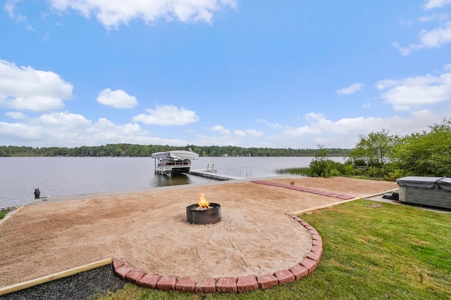 view of dock featuring a water view and a yard