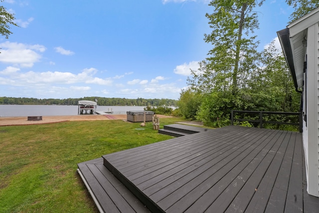 wooden terrace with a water view and a lawn