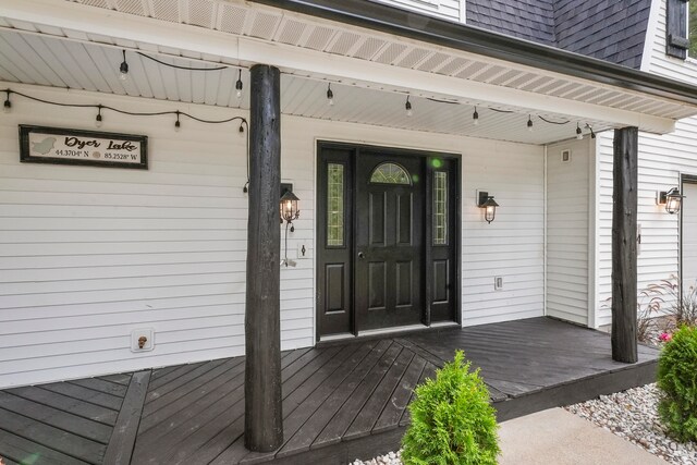 view of exterior entry with a porch