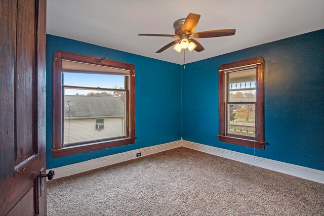 empty room featuring a healthy amount of sunlight and carpet