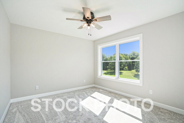 carpeted empty room featuring ceiling fan