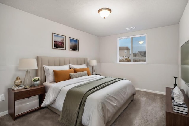 bedroom with dark colored carpet