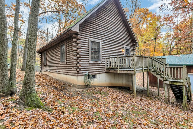 view of property exterior featuring a wooden deck