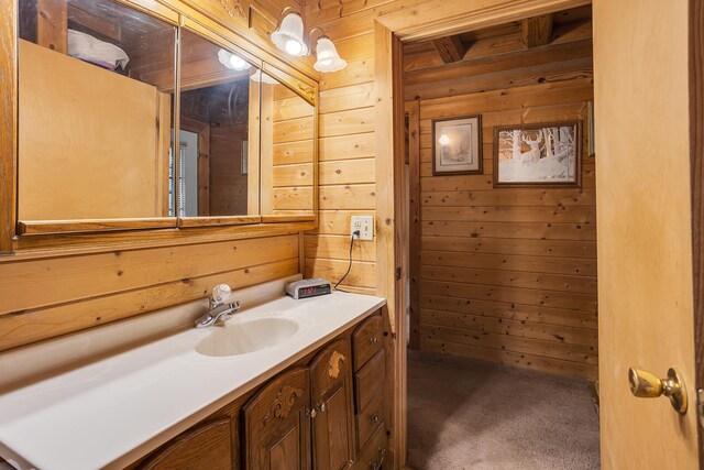 bathroom featuring vanity and wooden walls