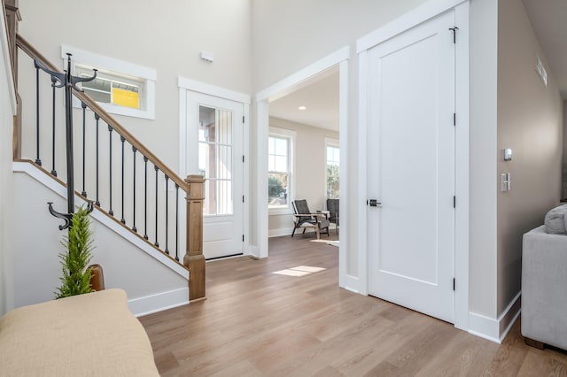 foyer entrance with light hardwood / wood-style floors