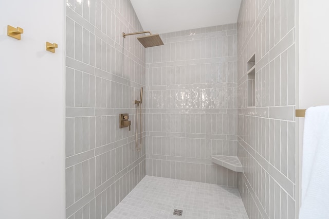 bathroom with a tile shower