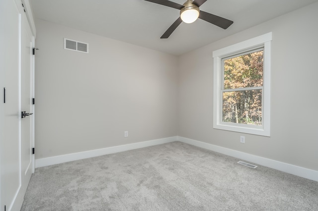 carpeted empty room featuring ceiling fan