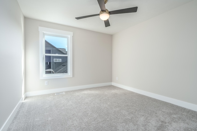 unfurnished room with carpet and ceiling fan