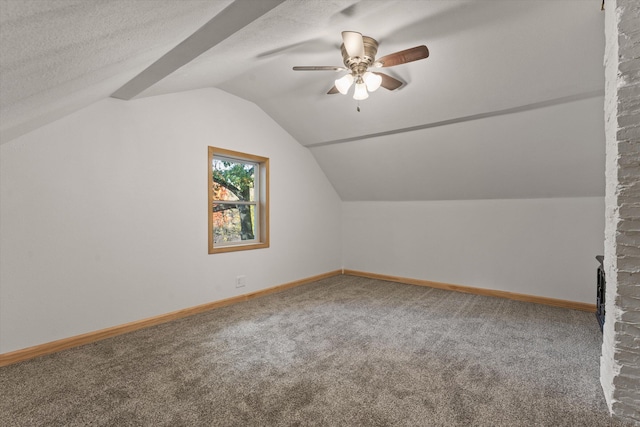 bonus room with lofted ceiling, a textured ceiling, carpet, and ceiling fan