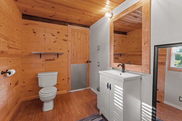 bathroom with wood ceiling, toilet, wooden walls, vanity, and hardwood / wood-style flooring