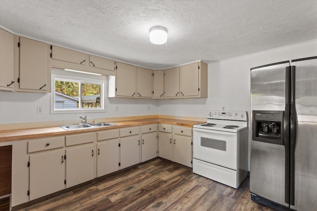 kitchen with cream cabinets, stainless steel fridge, white electric stove, and dark wood-type flooring