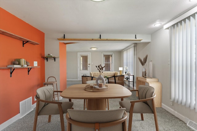 dining space with light colored carpet