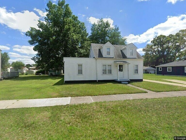 cape cod home with a front lawn