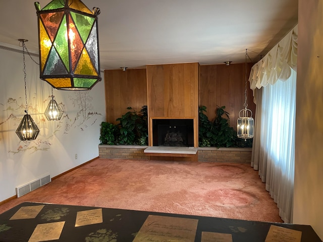 unfurnished living room with wood walls and carpet floors