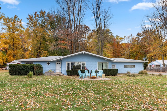 rear view of house featuring a lawn