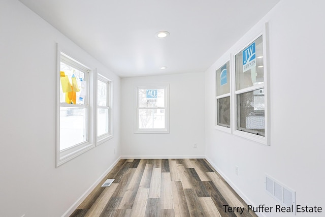 empty room with hardwood / wood-style flooring