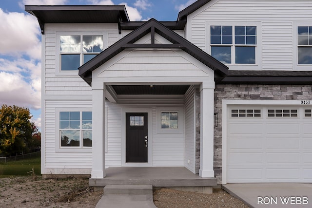 view of exterior entry featuring a garage