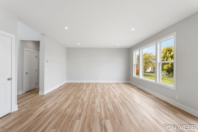 unfurnished room with light hardwood / wood-style floors