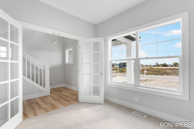 interior space with french doors, wood-type flooring, and plenty of natural light