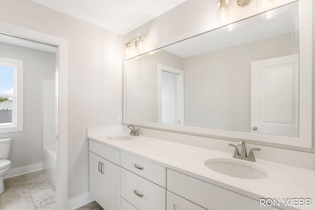 full bathroom featuring toilet, vanity, and tub / shower combination