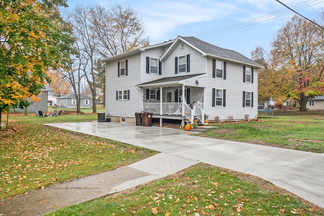 view of front facade with covered porch and a front yard