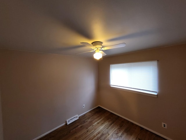 empty room with hardwood / wood-style floors and ceiling fan