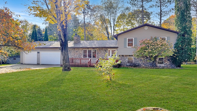 tri-level home featuring a wooden deck, a front yard, and a garage