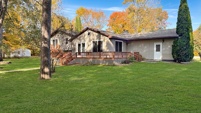 view of front of property featuring a front lawn and a wooden deck