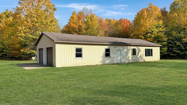 view of outbuilding with a lawn and a garage