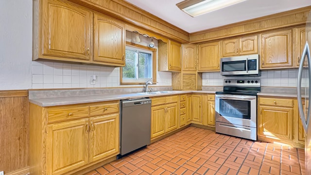 kitchen featuring appliances with stainless steel finishes, decorative backsplash, and sink