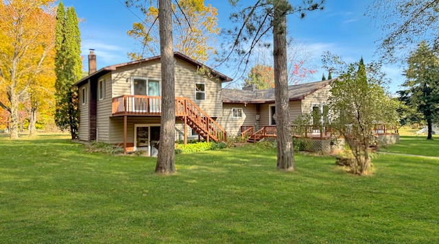 rear view of property with a wooden deck and a lawn