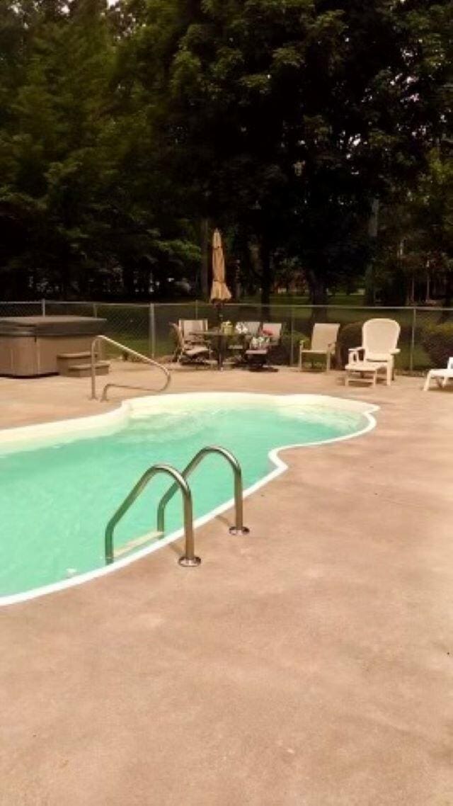 view of swimming pool featuring a patio area