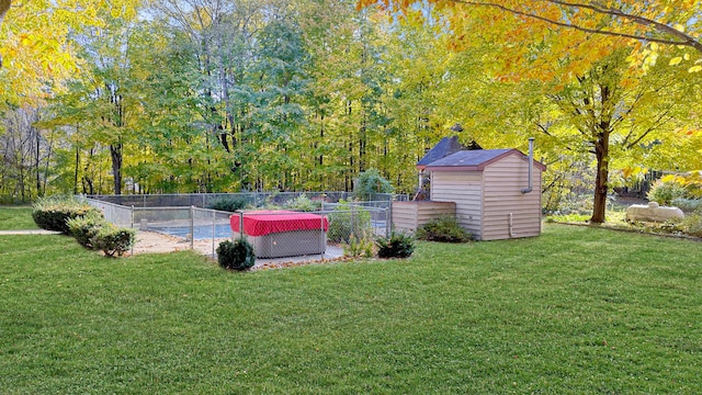 view of sport court with a storage unit and a lawn