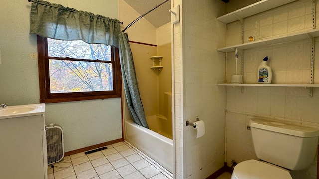 full bathroom featuring vanity, tile patterned floors, shower / tub combo, and toilet