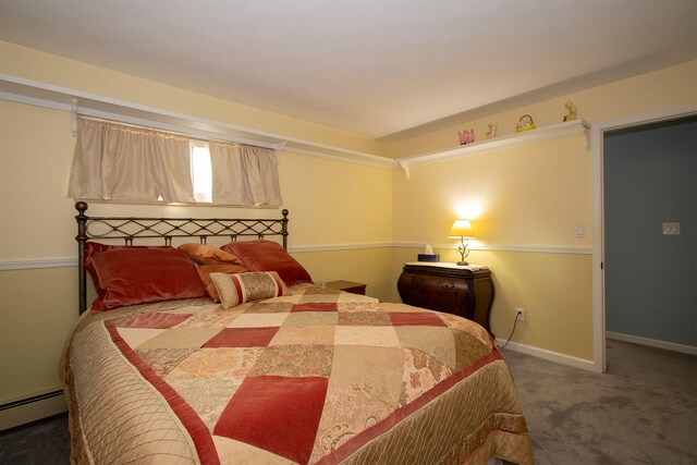 carpeted bedroom with a baseboard heating unit