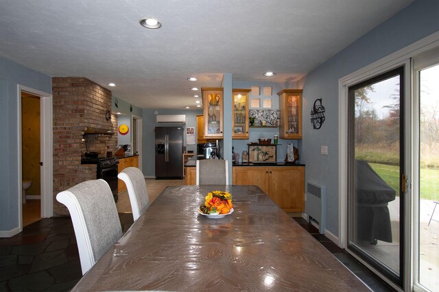 dining room with a textured ceiling and radiator heating unit