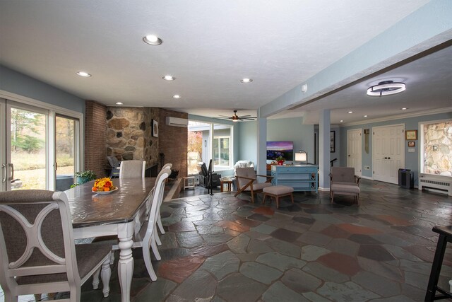 dining area featuring ornamental molding, a wall mounted AC, radiator heating unit, and ceiling fan